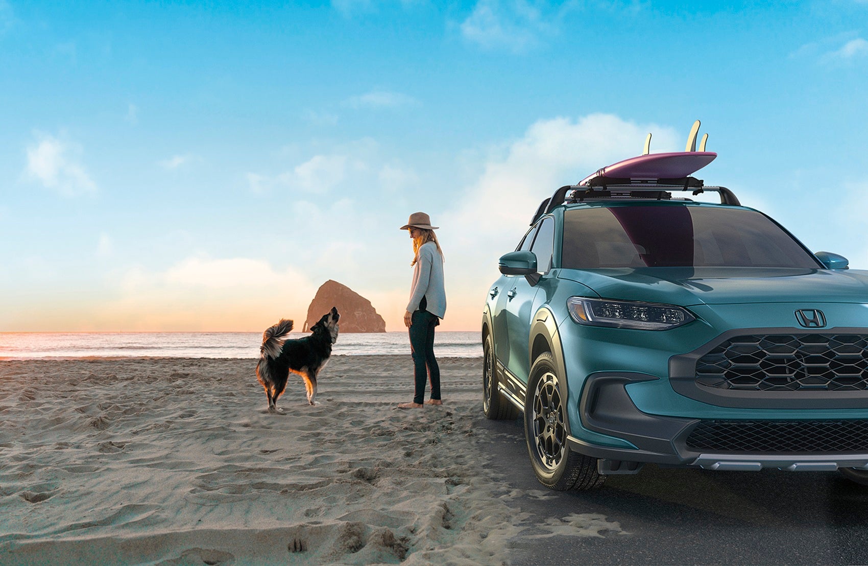 2026 Honda HR-V on a beach with woman and dog during sunset