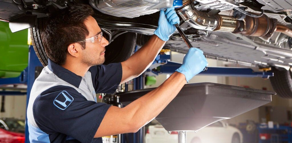 image of a Honda technician working on a car