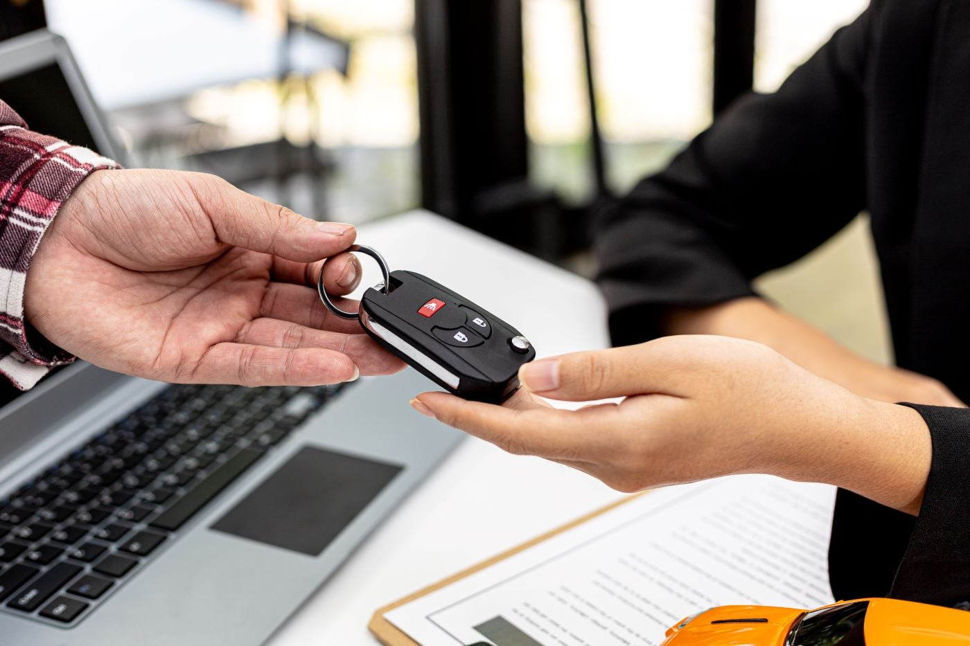 image of someone handing over a car key